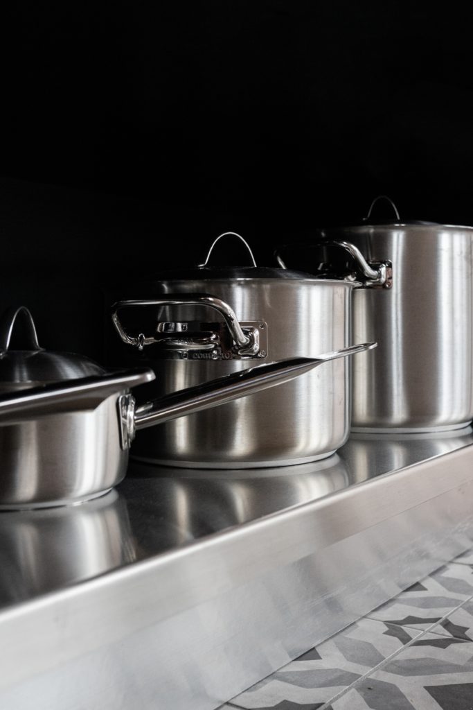 stainless steel cooking pots on stainless steel tray
